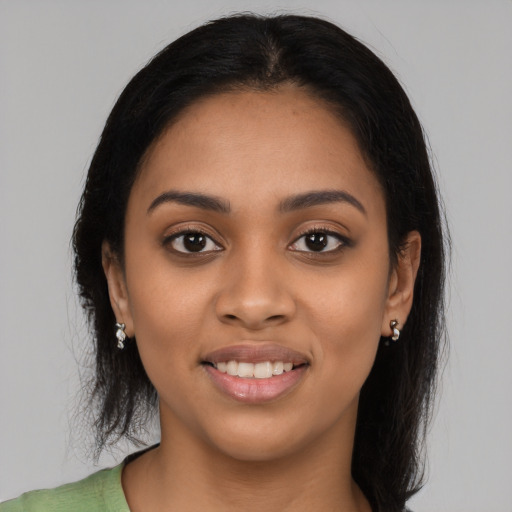 Joyful latino young-adult female with long  black hair and brown eyes