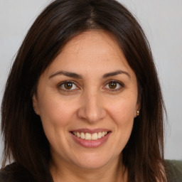 Joyful white adult female with long  brown hair and brown eyes