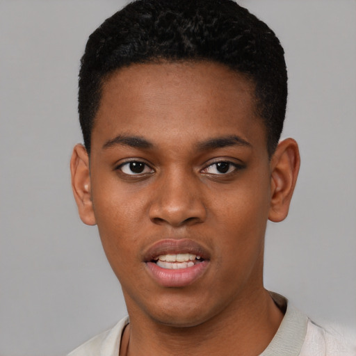 Joyful black young-adult male with short  black hair and brown eyes