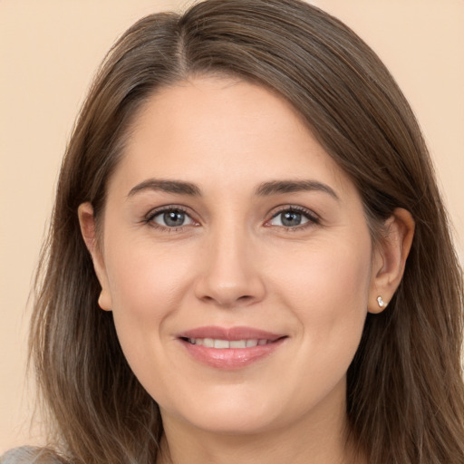 Joyful white young-adult female with long  brown hair and brown eyes