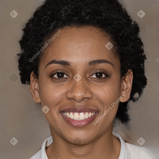 Joyful black young-adult female with short  black hair and brown eyes