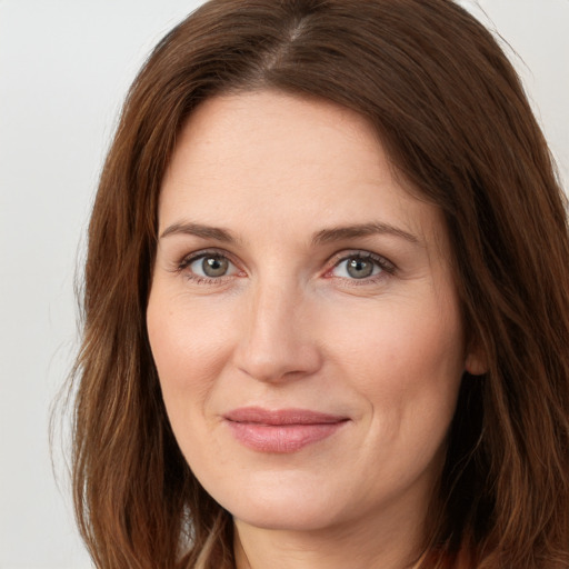 Joyful white young-adult female with long  brown hair and grey eyes