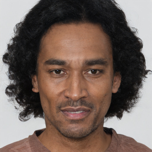 Joyful latino adult male with short  black hair and brown eyes