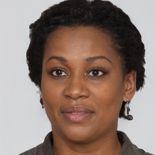 Joyful black adult female with short  brown hair and brown eyes