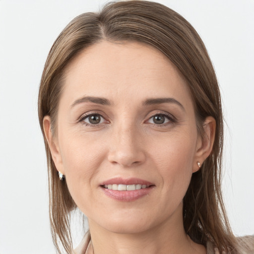 Joyful white young-adult female with long  brown hair and grey eyes