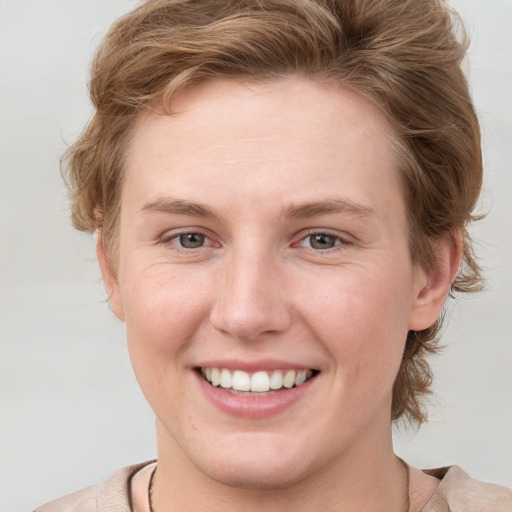 Joyful white young-adult female with medium  brown hair and blue eyes