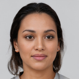 Joyful latino young-adult female with medium  brown hair and brown eyes