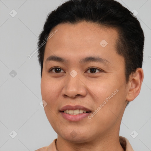 Joyful asian young-adult male with short  brown hair and brown eyes