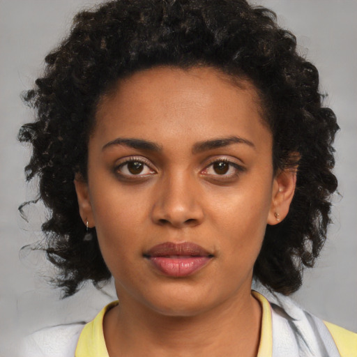 Neutral black young-adult female with medium  brown hair and brown eyes