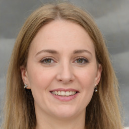 Joyful white young-adult female with long  brown hair and green eyes