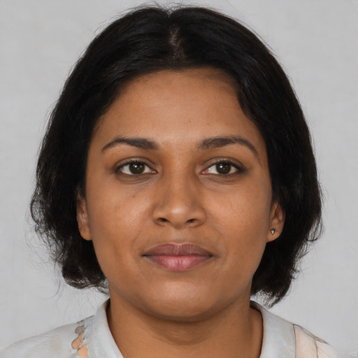 Neutral black young-adult female with medium  brown hair and brown eyes