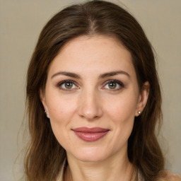 Joyful white young-adult female with long  brown hair and green eyes