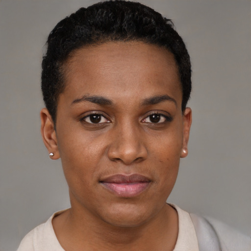 Joyful black young-adult female with short  black hair and brown eyes