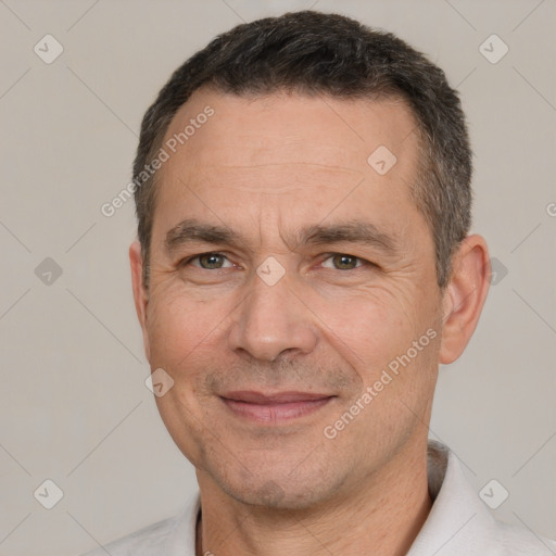 Joyful white adult male with short  black hair and brown eyes