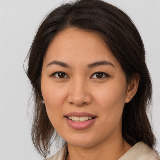 Joyful white young-adult female with medium  brown hair and brown eyes