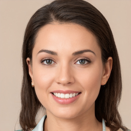 Joyful white young-adult female with medium  brown hair and brown eyes