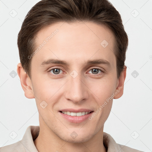 Joyful white young-adult male with short  brown hair and grey eyes