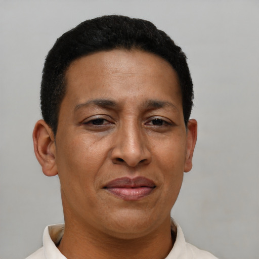 Joyful latino adult female with short  brown hair and brown eyes