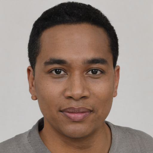 Joyful black young-adult male with short  black hair and brown eyes
