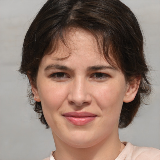 Joyful white adult female with medium  brown hair and brown eyes