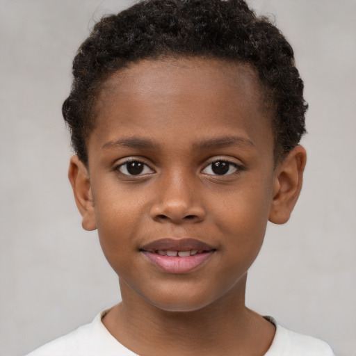 Joyful black child male with short  brown hair and brown eyes