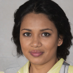 Joyful black adult female with medium  brown hair and brown eyes