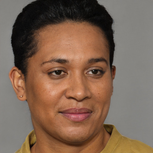 Joyful latino adult female with short  black hair and brown eyes