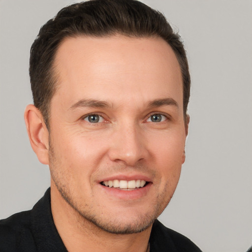 Joyful white young-adult male with short  brown hair and brown eyes