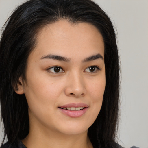Joyful asian young-adult female with long  brown hair and brown eyes