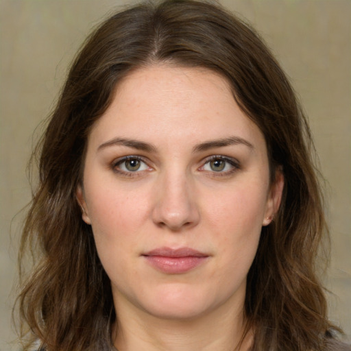 Joyful white young-adult female with long  brown hair and green eyes