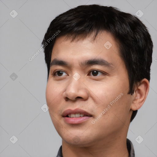 Joyful asian young-adult male with short  black hair and brown eyes