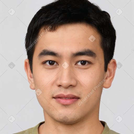 Joyful asian young-adult male with short  black hair and brown eyes