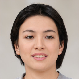 Joyful asian young-adult female with medium  black hair and brown eyes