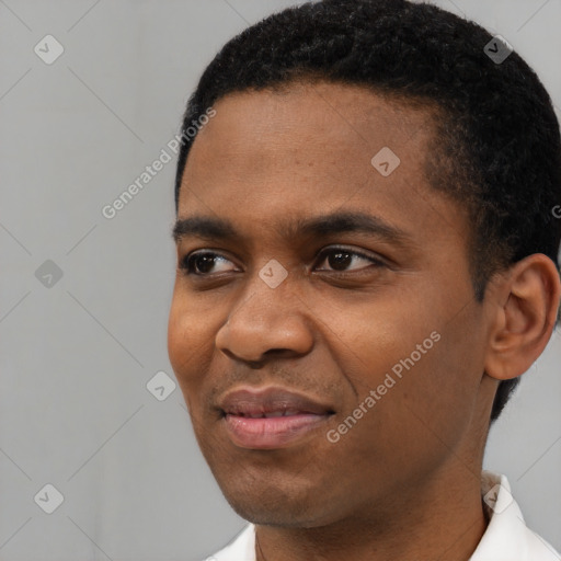 Joyful black young-adult male with short  black hair and brown eyes