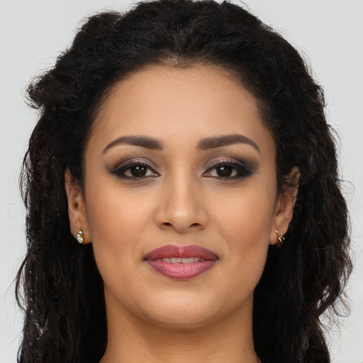 Joyful latino young-adult female with long  brown hair and brown eyes
