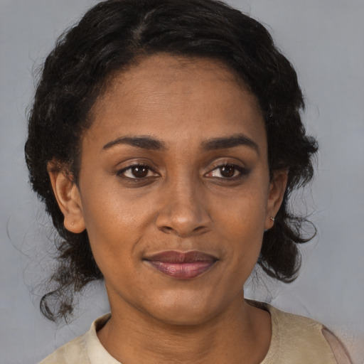 Joyful latino adult female with medium  brown hair and brown eyes