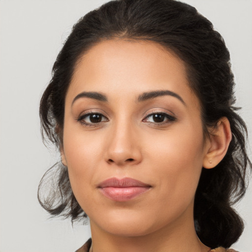 Joyful latino young-adult female with medium  brown hair and brown eyes