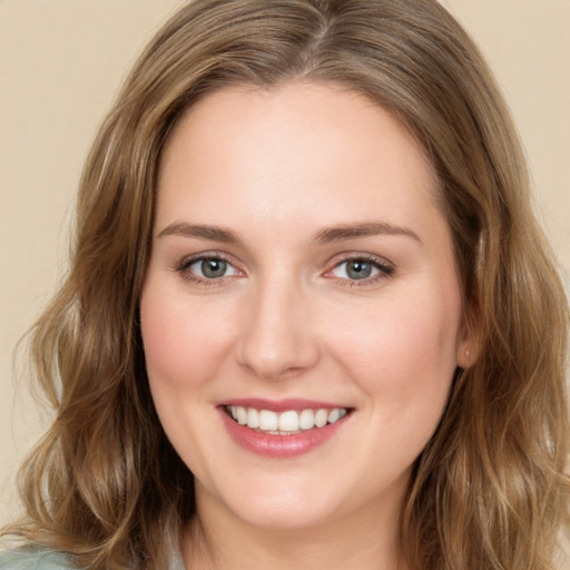 Joyful white young-adult female with long  brown hair and green eyes