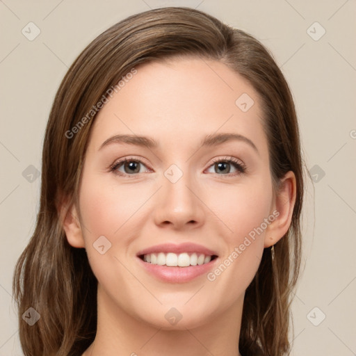 Joyful white young-adult female with long  brown hair and green eyes