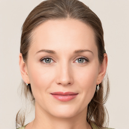 Joyful white young-adult female with medium  brown hair and grey eyes