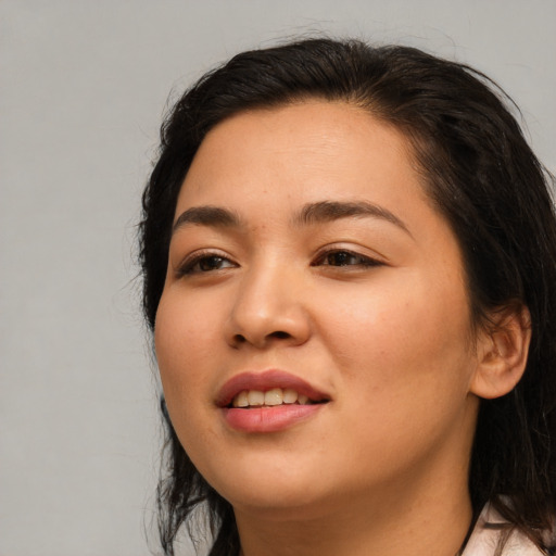 Joyful asian young-adult female with long  brown hair and brown eyes