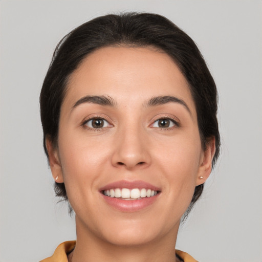 Joyful white young-adult female with medium  brown hair and brown eyes