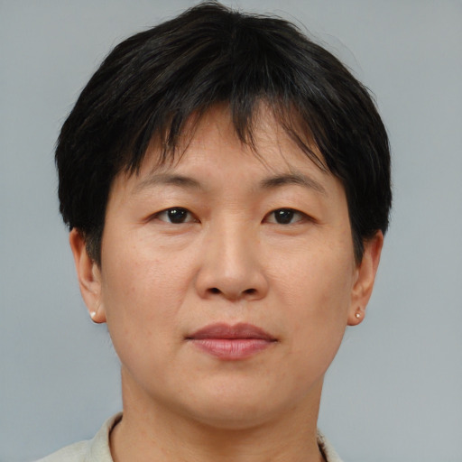 Joyful asian adult female with short  brown hair and brown eyes