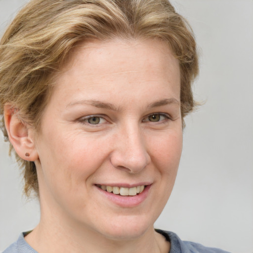 Joyful white adult female with medium  brown hair and blue eyes