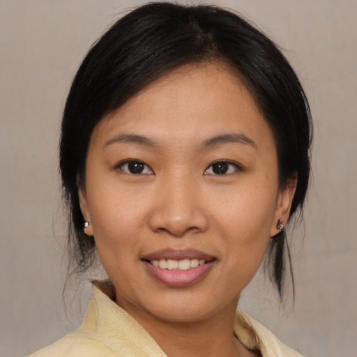 Joyful asian young-adult female with medium  brown hair and brown eyes