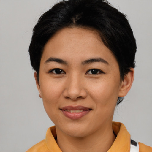 Joyful asian young-adult female with short  black hair and brown eyes