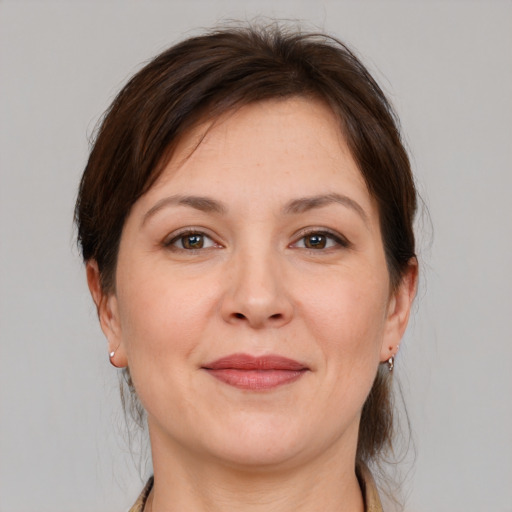 Joyful white adult female with medium  brown hair and brown eyes