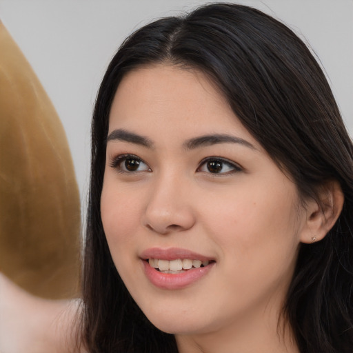 Joyful white young-adult female with long  black hair and brown eyes