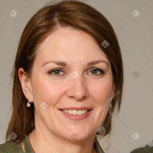 Joyful white adult female with medium  brown hair and green eyes