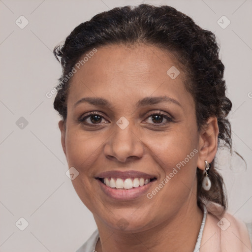 Joyful latino young-adult female with short  brown hair and brown eyes